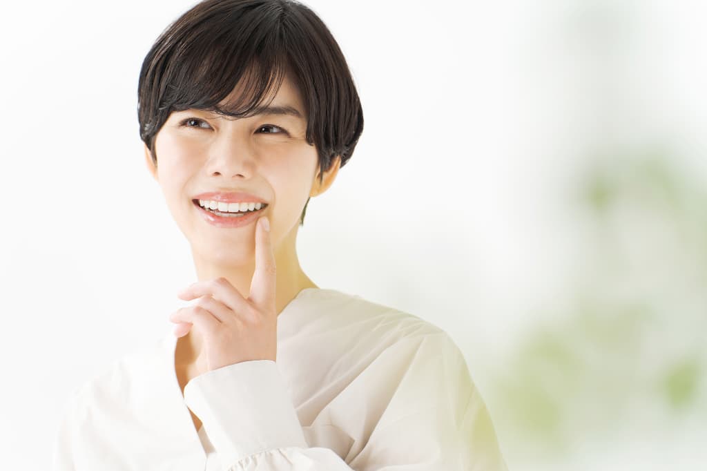 歯の矯正を計画どおりに終わらせることができ満足している女性